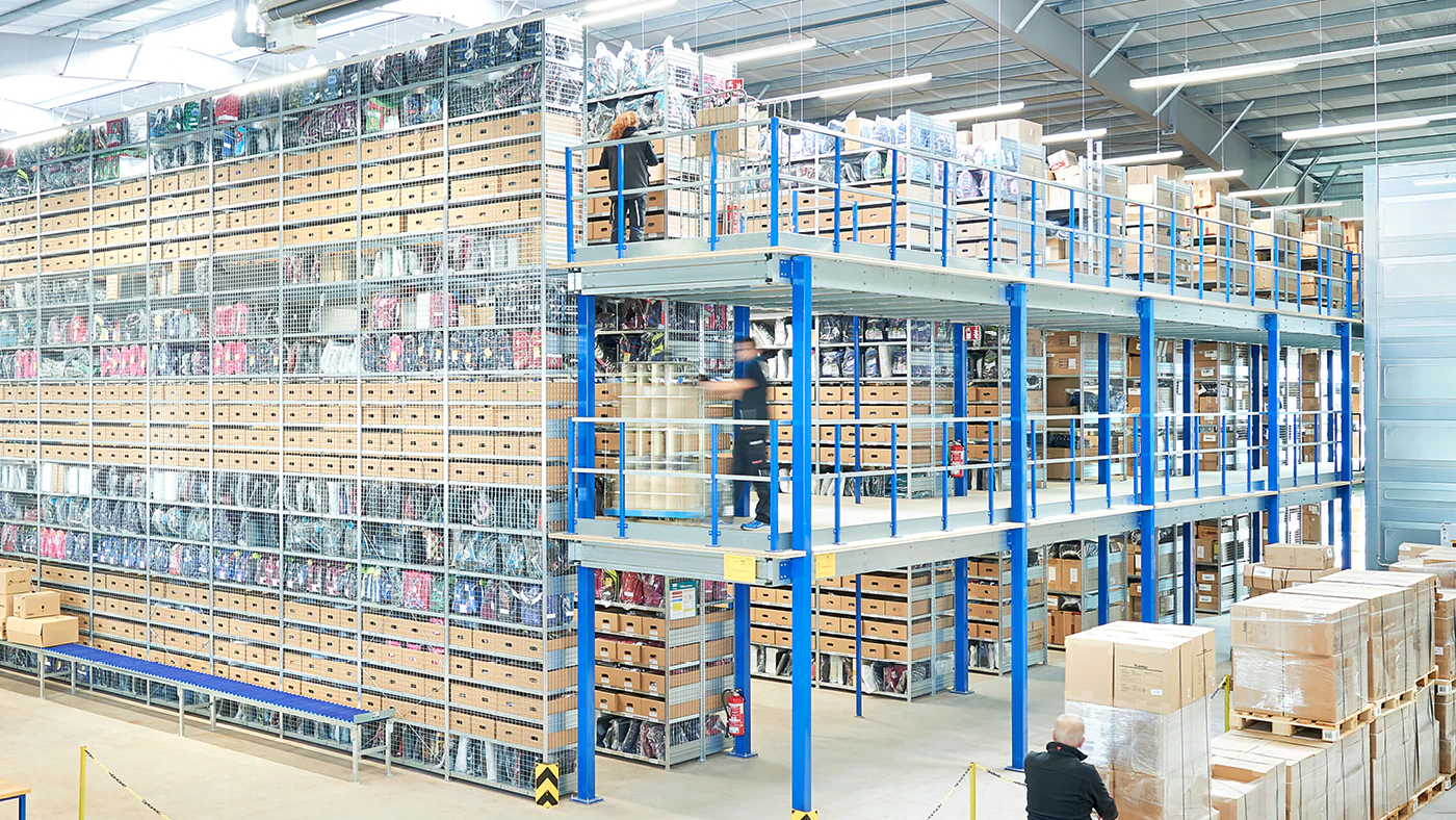 De foto laat legbordstellingen zien die in meerdere niveaus zijn opgebouwd in een magazijn.