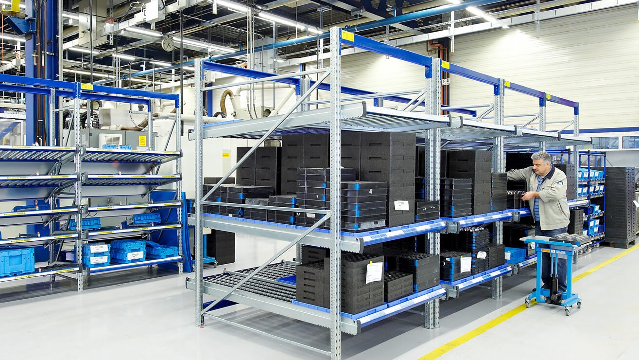 Ein Mann der ein Durchlaufregal einräumt