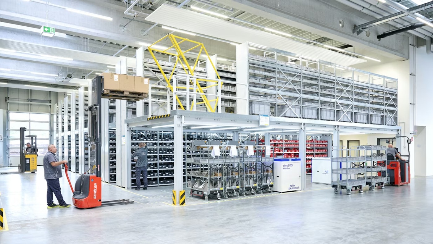 De foto laat een nieuw magazijn zien, met verdieping en diverse opslagsystemen.