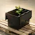 Black storage box with plant on wooden pallet
