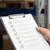 Man holds a checklist in a warehouse