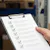 Man holds a checklist in a warehouse