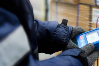 Mitarbeiter kontrolliert die Temperatur in einem Kühllager